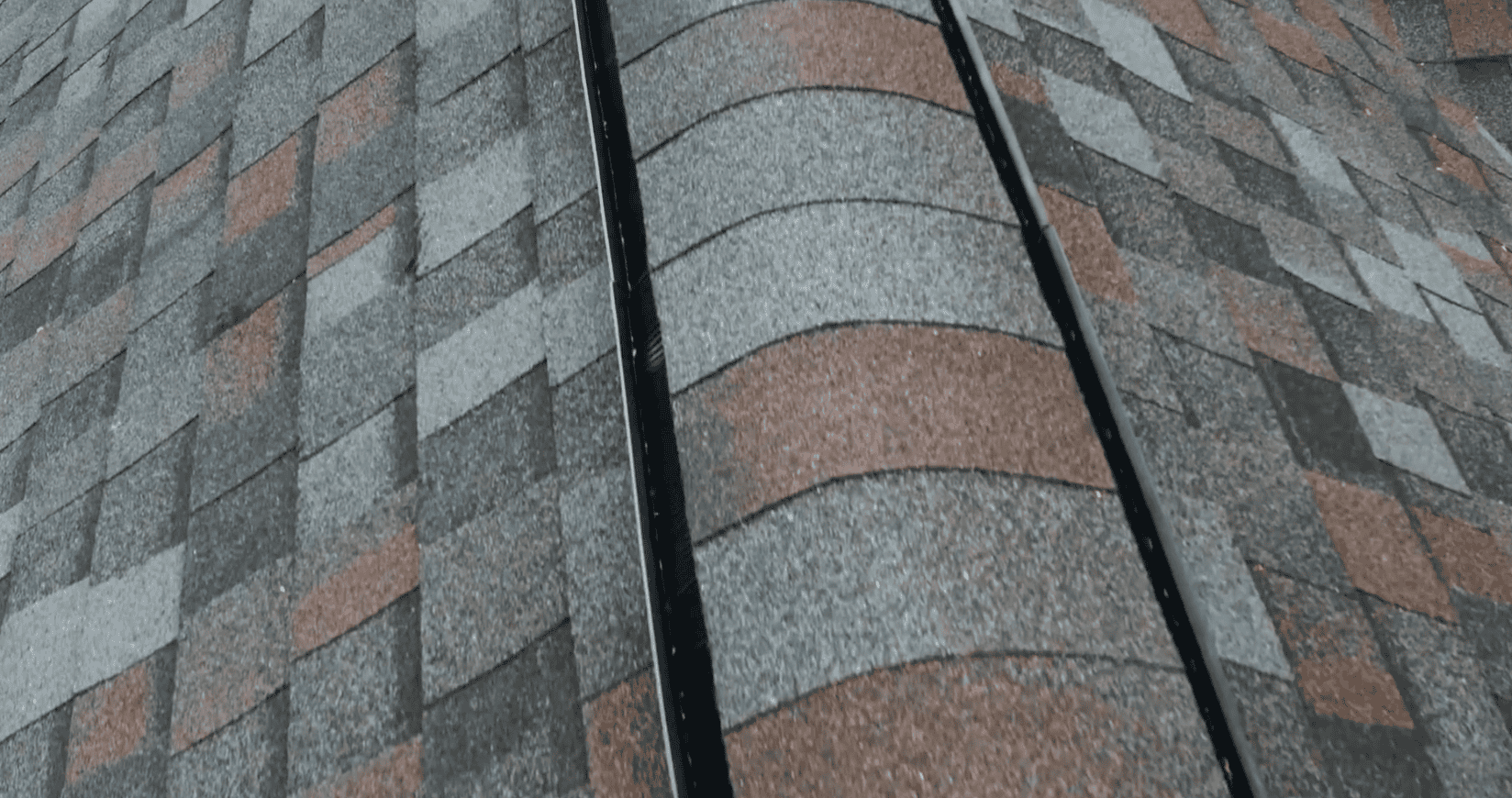 Close-up view of completed architectural roofing shingles and ridge shingles